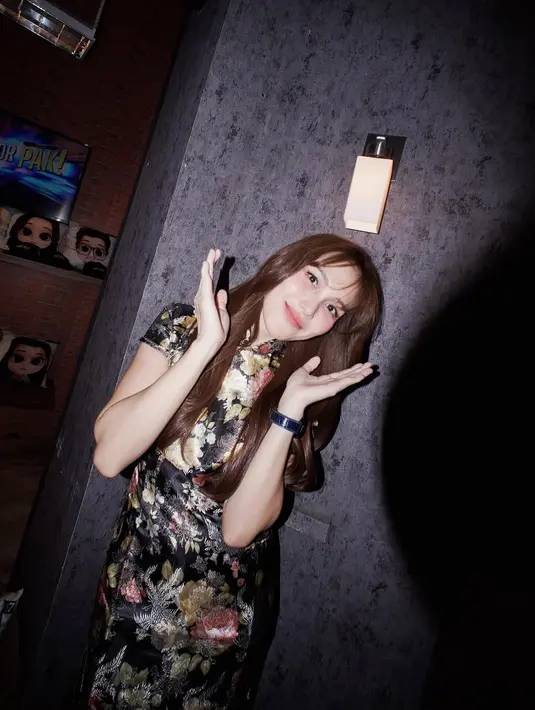 Motif bunga dengan aksen emas dan merah menghiasi kain satin berkilau, memberikan nuansa mewah yang tetap anggun. Ayu memilih tata rambut lurus panjang yang dibiarkan tergerai, menambah kesan effortless beauty yang tetap memikat. [@ayutingting92].