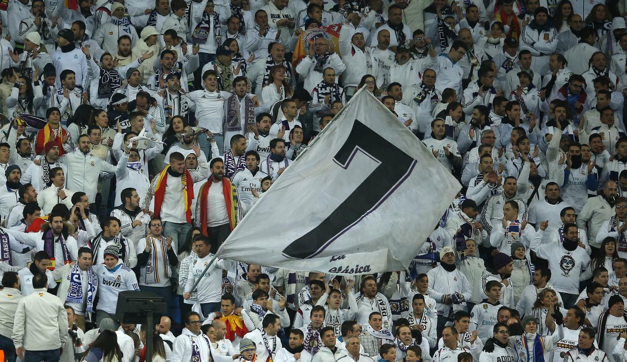 Suporter Real Madrid mengibarkan bendera raksasa saat melawan Dortmund pada laga Liga Champions di Stadion Santiago Bernabeu, Madrid, Rabu (6/12/2017). Madrid menang 3-2 atas Dortmund. (AP/Paul White)
