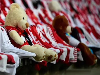 Teddy bears duduk di antara kaus pendukung sebelum pertandingan antara FC Cologne vs RB Leipzig pada lanjutan Bundesliga divisi satu Jerman di Cologne (1/6/2020). Pertandingan yang digelar tanpa penontona akibat pandemi Covid-19 ben ini dimenangkan RB Leipzig dengan skor 4-2. (AFP/Ina Fassbender)