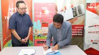 CEO Telin Hong Kong, Indarto Nata menandatangani kerja sama PT Kreatif Media Karya (KMK Online) dan PT Telekomunikasi Indonesia Internasional atau Telin di Jakarta (18/8). (Liputan6.com/Fatkhur Rozaq)