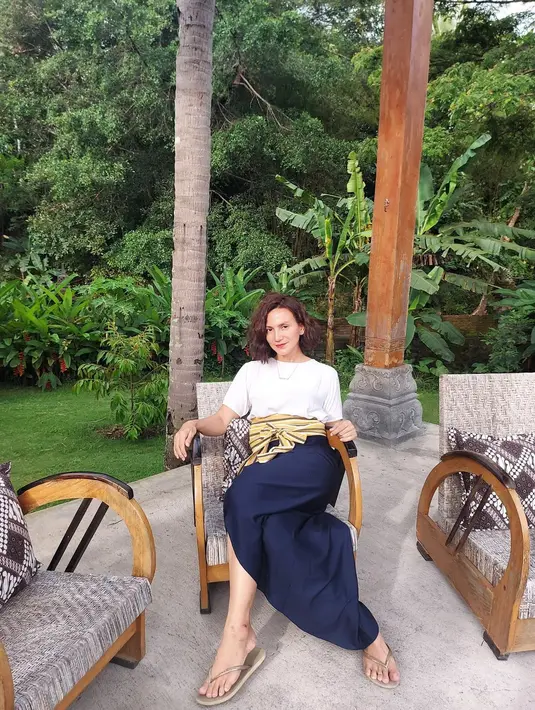 Wanda Hamidah memasangkan kaus putih dengan kain sebagai pengganti bawahan celana atau rok yang terlihat chic. (Foto: Instagram @wanda_hamidah)