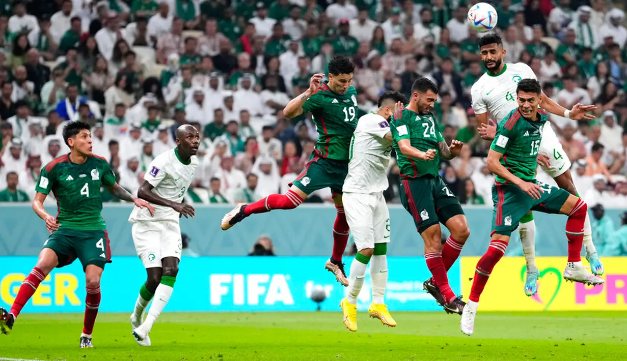 Pemain Arab Saudi Abdulelah Al-Amri (kanan) melakukan sundulan saat melawan Meksiko pada pertandingan sepak bola Grup C Piala Dunia 2022 di Stadion Lusail, Lusail, Qatar, 30 November 2022. Meksiko menang 2-1 tetapi gagal melaju ke babak 16 besar Piala Dunia 2022. (AP Photo/Manu Fernandez)