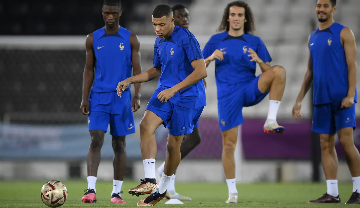 Pemain depan Prancis Kylian Mbappe menendang bola saat sesi latihan di Al Sadd SC di Doha, Selasa (13/12/2022). Duel Prancis vs Maroko pada Kamis dinihari WIB di semifinal Piala Dunia 2022 menjadi laga yang dinantikan. (Photo by FRANCK FIFE / AFP)