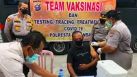 Tim Vaksin Covid-19 Polresta Pekanbaru memberikan vaksin kepada warga di perumahan. (Liputan6.com/M Syukur)