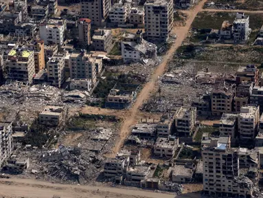 Bangunan-bangunan yang hancur terlihat dari jendela pesawat Angkatan Udara Amerika Serikat (AS) di Jalur Gaza, Kamis, 14 Maret 2024. (AP Photo/Leo Correa)