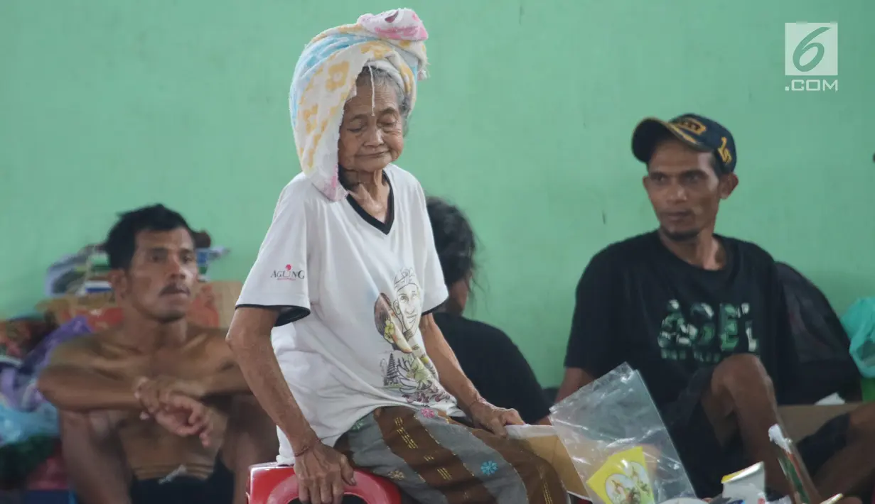 Aktivitas seorang lanjut usia (lansia) di GOR Swecapura, Klungkung, Bali, Senin (27/11). Berdasarkan perkiraan BNPB, ada lebih dari 40.000 warga desa di sekitar Gunung Agung yang telah mengungsi sejak Sabtu, 25 November 2017. (Liputan6.com/Andi Jatmiko)