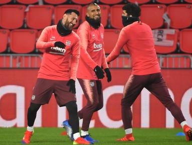 Lionel Messi dan Arturo Vidal tampak menikmati saat latihan berlangsung jelang digelarnya laga lanjutan Grup B Liga Champions kontra PSV Eindhoven, Rabu (28/11). Dalam laga kali ini Luis Suarez diragukan tampil karena cedera. (AFP/Emmanuel Dunand)