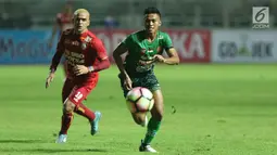 Bek PS TNI, Ganjar Mukti (kanan) berebut bola dengan pemain depan Arema FC, Cristian Gonzales dilanjutan Liga 1 Indonesia di Stadion Pakansari, Bogor, Senin (3/7). Laga kedua tim berakhir imbang 0-0. (Liputan6.com/Helmi Fithriansyah)