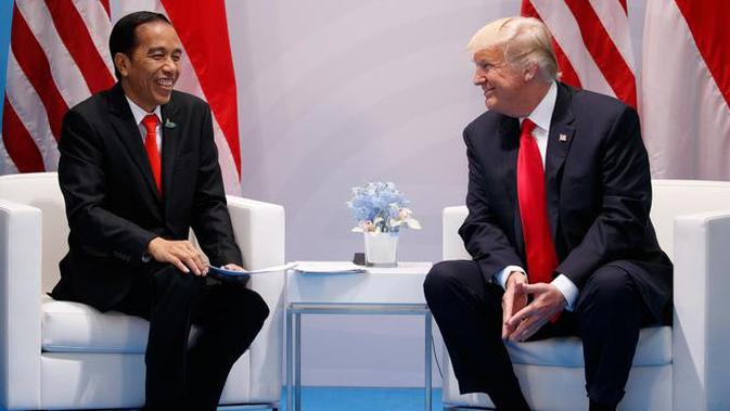 Presiden AS Donald Trump dan Presiden RI, Joko Widodo berbincang saat bertemu di sela-sela KTT G20 di Hamburg, Jerman, (8/7). Sejumlah pemimpin negara berkumpul dalam KTT G20 pada 7-8 Juli 2017. . (AP Photo/Evan Vucci)