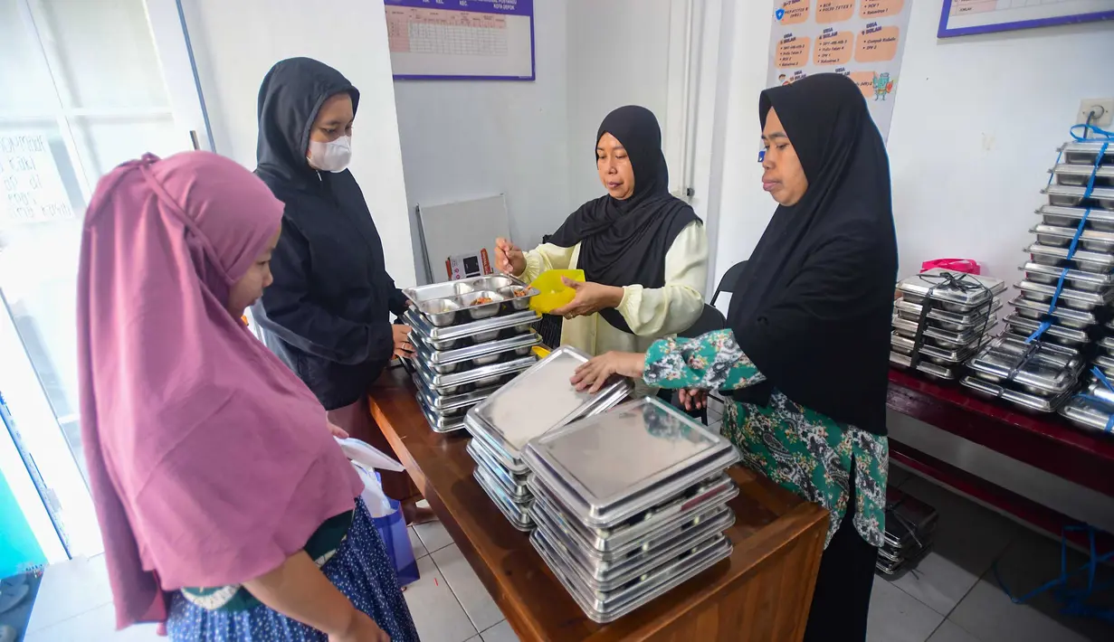 Ibu hamil mengambil makan bergizi gratis (MBG) untuk dikonsumsi di rumah di Posyandu kawasan Limo, Depok, Jawa Barat, Selasa (14/7/2025).