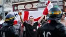 Suporter Inggris bersorak didepan petugas jelang pertandingan melawan Wales di Lille, Prancis, (15/6). UEFA mengancam akan mendiskualifikasi tim Inggris dari Piala Eropa 2016 jika para suporter membuat kerusuhan kembali. (REUTERS/Wolfgang Rattay)