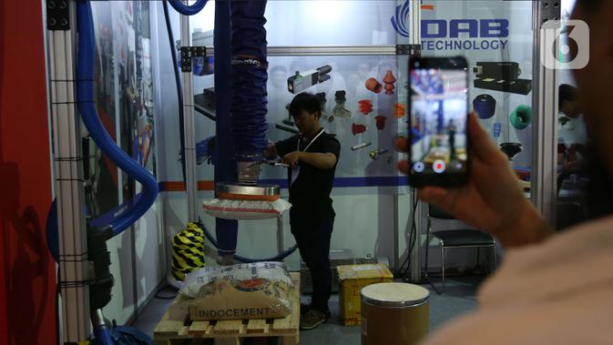 Pengunjung melihat peralatan industri yang dipamerkan  dalam Manufacturing Indonesia 2019 di JIExpo, Kemayoran, Jakarta, Rabu (4/12/2019). Pameran menampilkan beragam teknologi, layanan manufaktur terbaru dan terbaik dari para pemain kunci dibidangnya. (Liputan6.com/Angga Yuniar)