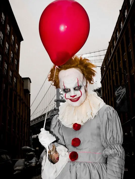 Ed Sheeran berpakaian seperti badut film menakutkan ikonik Pennywise. Penampilan Ed Sheeran sebagai Pennywise totalitas dengan Cat wajah, wig, dan senyumnya yang meresahkan lebih memancarkan nuansa film horor. Ia juga mengenakan baju badut warna abu-abunya. Lengkap membawa balon merah. [@teddysphotos]