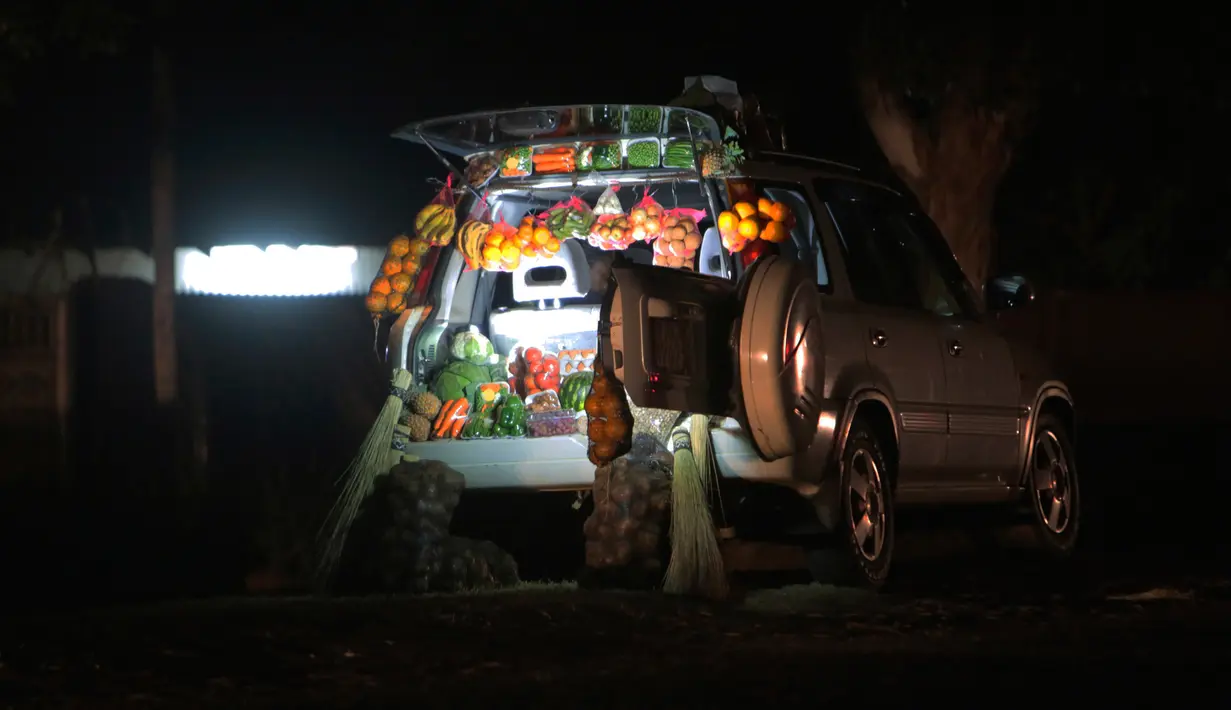Sebuah mobil memajang buah-buahan dan sayuran saat berjualan di sisi jalan yang sibuk di Harare, 23 Juni 2020. Mobil menjadi pasar bergerak di mana penduduk Zimbabwe menjual barang dagangan dari kendaraan untuk mengatasi kesulitan ekonomi yang disebabkan Covid-19. (AP Photo/Tsvangirayi Mukwazhi)