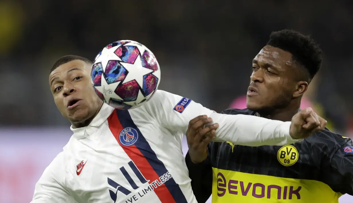 Penyerang PSG, Kylian Mbappe berebut bola dengan bek Dortmund, Dan-Axel Zagadou pada pertandingan leg pertama babak 16 Liga Champions di Dortmund, Jerman (18/2/2020). Dortmund menang 2-0 atas PSG. (AP Photo/Michael Probst)