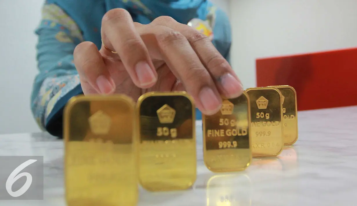 Petugas menunjukan emas batangan di Jakarta, Rabu (13/7). Harga buyback emas batangan dibuka turun di Rp 8.000/gram. (Liputan6.com/Angga Yuniar)