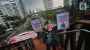 Sejumlah aktivis yang tergabung dalam Extintion Rebellion (XR) dan Walhi Jakarta melakukan aksi di JPO Pinisi, Jalan Jenderal Sudirman, Jakarta, Senin (14/11/2022). Aksi tersebut dilakukan untuk menyerukan kepada para pemimpin agar menghentikan “pencucian hijau” dan praktik ekonomi “business-as-usual” yang secara sistematis memperburuk krisis iklim dan mendorong umat manusia pada kehancuran ekologis & kepunahan massal. Negara-negara G20 turut menyumbang atas 80 persen emisi karbon dunia dan 60 persen populasi penduduk bumi. (Liputan6.com/Angga Yuniar)