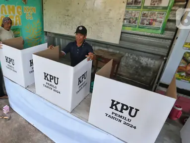 Warga mempersiapkan bilik suara Pemilu 2024 di Tempat Pemungutan Suara (TPS) 009, Petukangan Selatan, Jakarta, Selasa (13/2/2024). (Liputan6.com/Angga Yuniar)