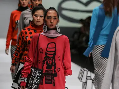 Model disabilitas mengenakan busana rancangan kolaborasi Cotton Ink x Intoart yang digawangi British Council pada Jakarta Fashion Week 2020 di Senayan, Kamis (24/10/2019). Kolaborasi ini menampilkan model disabilitas yang terdiri dari down syndrome, tuna daksa dan tuli. (Liputan.com/Johan Tallo)