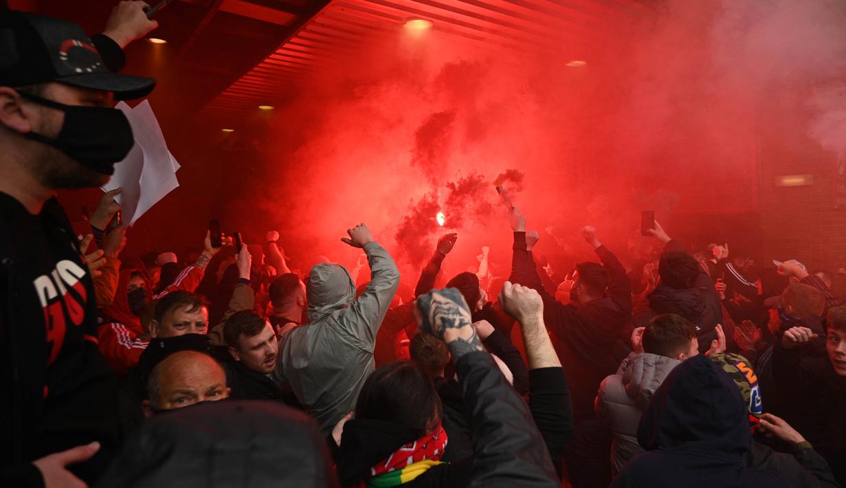 Ribuan suporter Manchester United mencoba untuk memaksa masuk ke dalam stadion Old Trafford saat mereka memprotes keluarga Glazer menjelang pertandingan Liga Premier Inggris melawan Liverpool. (Foto: AFP/Oli Scarff)