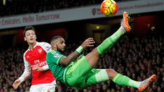 Pemain Arsenal, Mesut Ozil (kiri) melihat gelandang Sunderland, Yann M'vila, saat menendang salto dalam laga Liga Inggris di Stadion Emirates, London, (5/12/2015). (AFP/IKIMAGES/Ian Kington) 