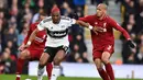 Aksi Ryan Babel lewati hadangan Fabinho pada laga lanjutan Premier League yang berlangsung di Stadion Craven Cottage, London, Minggu (17/3). Liverpool menang 2-1 atas Fulham. (AFP/Glyn Kirk)