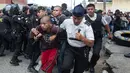Petugas polisi membawa narapidana yang ditangkap dari penjara Juvenile Gaviotas di Guatemala City, Guatemala (3/7). Kerusuhan di penjara tersebut terjadi usai dua narapidana ditemukan tewas tergantung. (AP Photo / Moises Castillo)