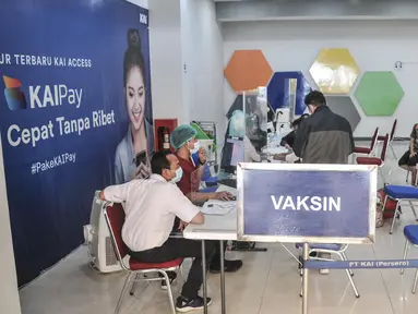Calon penumpang saat melakukan vaksinasi booster sebelum keberangkatan di Stasiun Pasar Senen, Jakarta Pusat, Minggu (17/7/2022). PT KAI mulai hari ini kembali memberlakukan syarat wajib bagi penumpang kereta jarak jauh, antara lain tes PCR bagi yang baru vaksin pertama dan tes antigen untuk vaksin kedua sebagai langkah mencegah penyebaran Covid-19. (merdeka.com/Iqbal S Nugroho)