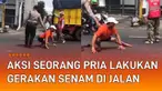 Aksi seorang pria lakukan gerakan senam di tengah jalan mengundang perhatian