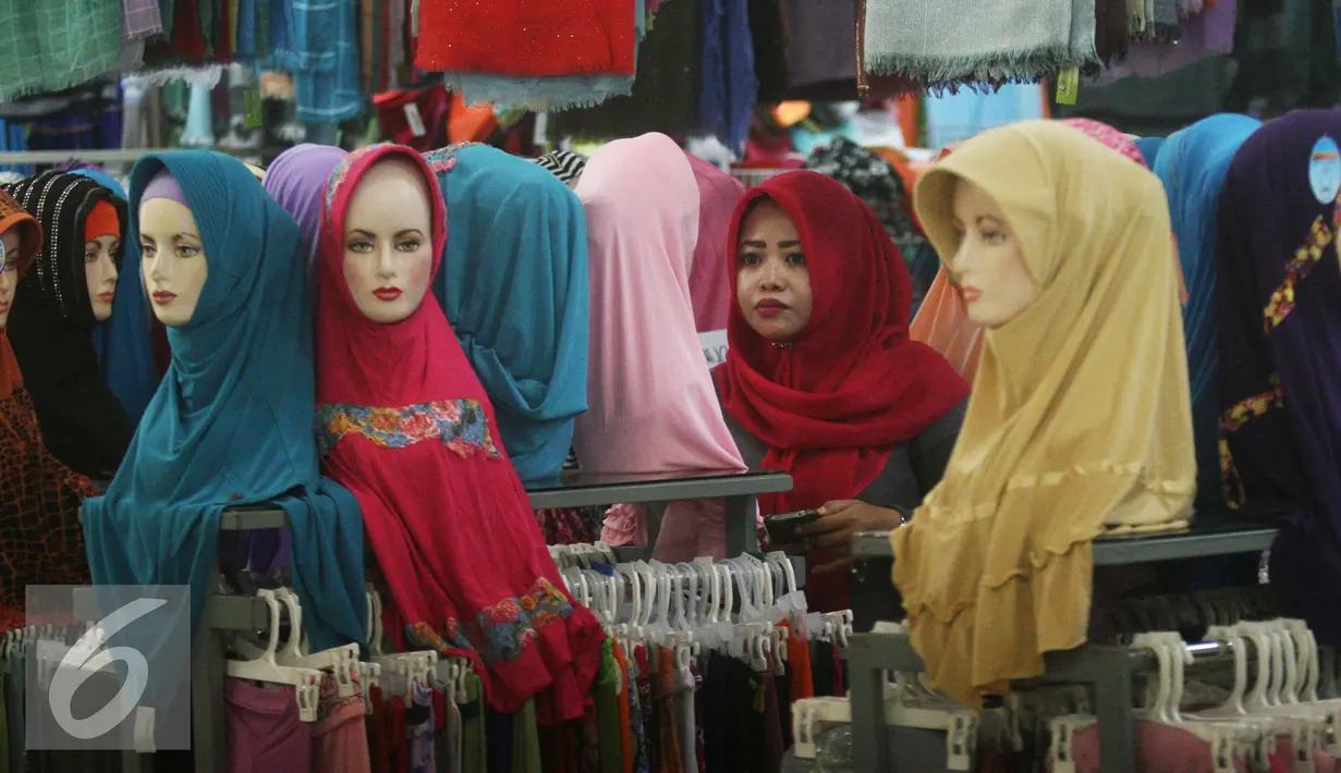 Seorang paramuniaga mengawasi model jilbab yang di jual di pasar Beringharjo, Yogyakarta, Rabu, (8/6/2016). Saat bulan ramadan, penjualan pakaian muslim mengalami peningkatan. (Liputan6.com/Boy Harjanto)