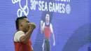 Lifter Eko Yuli usai melakukan angkatan saat SEA Games 2019 cabang angkat besi nomor 61 kg di Stadion Rizal Memorial, Manila, Minggu (1/12). Dirinya meraih emas dengan total angkatan 309 kg. (Bola.com/M Iqbal Ichsan)