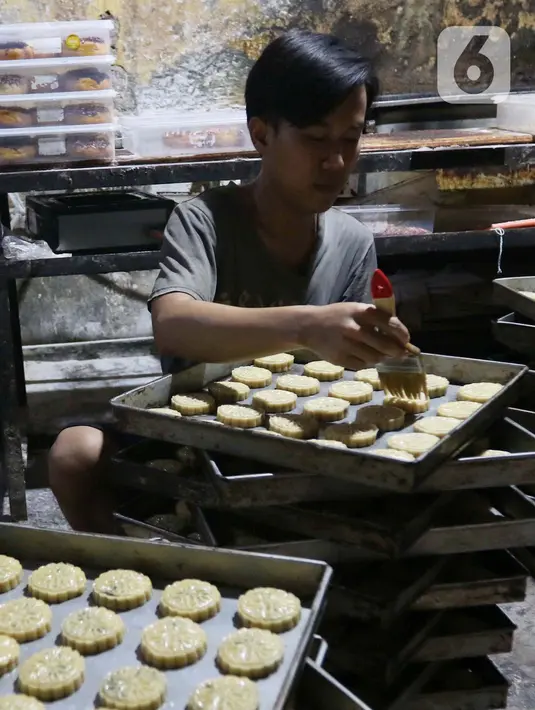 Pejerja tengah membuat kue kering di kawasan Kebayoran, Jakarta, Minggu (27/2/2022). Kemenkop UKM akan terus mendorong pelaku UMKM agar terhubung ke dalam ekosistem digital. Kemenkop UKM menargetkan 30 juta UMKM bisa terhubung ke dalam ekosistem digital pada tahun 2024. (Liputan6.com/Angga Yuniar)