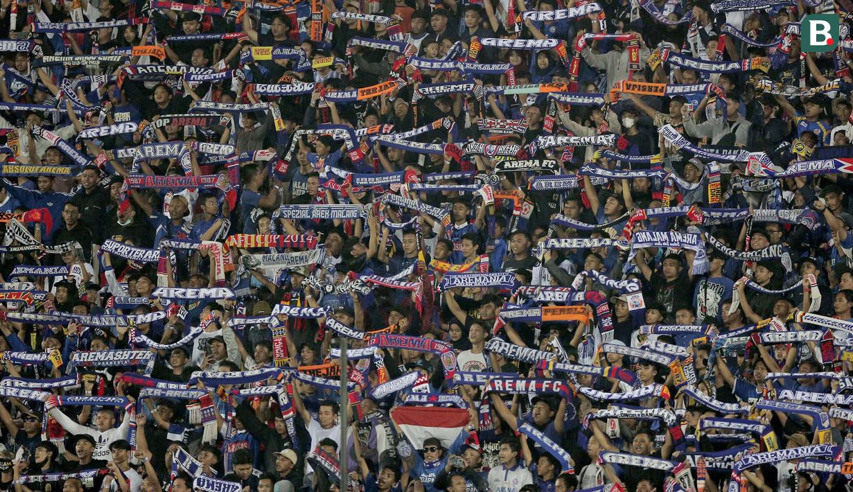 Aremania beraksi saat mendukung Arema FC bertanding melawan Persik Kediri dalam lanjutan pertandingan babak penyisihan Piala Presiden 2022 di Stadion Kanjuruhan, Malang, Jawa Timur. Rabu (15/6/2022). (Bola.com/Arief Bagus)