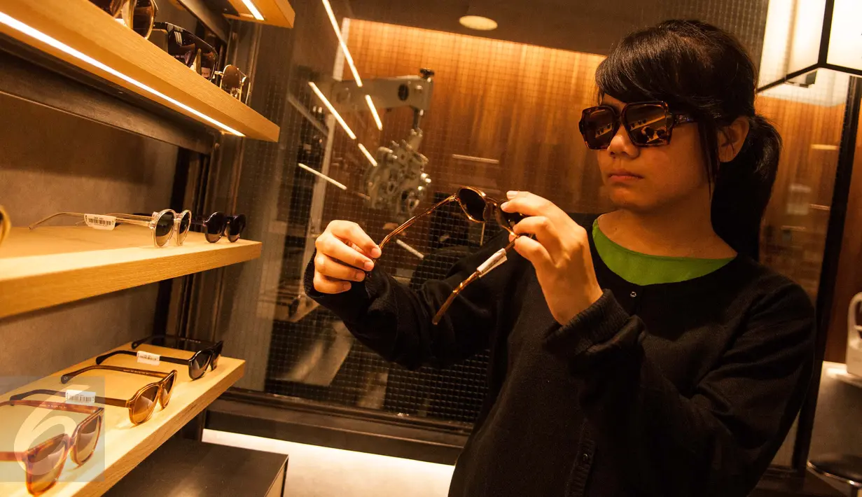 Pengunjung mencoba kacamata Bridges di Senayan City, Jakarta, Rabu (17/5). Bridges Eyewear, brand lokal yang menawarkan ragam koleksi kacamata stylish kembali membuka gerai terbarunya di Senayan City, Jakarta. (Liputan6.com/Gempur M Surya)