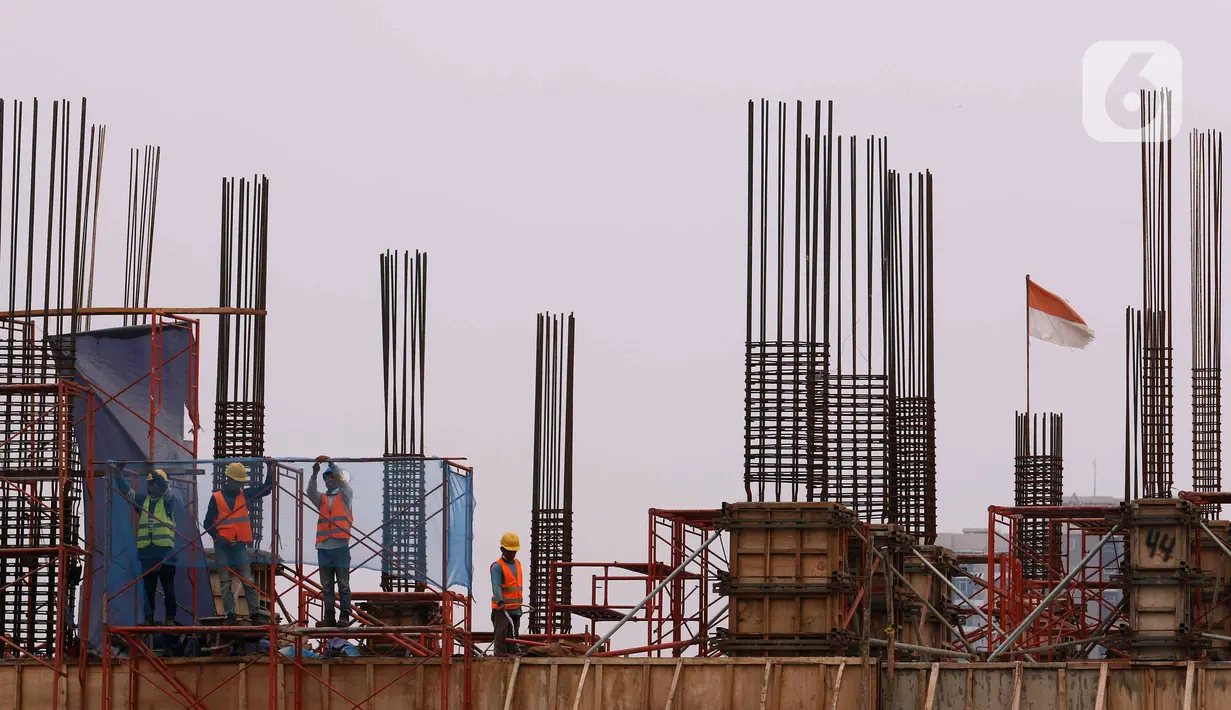 Pekerja tengah membangun gedung bertingkat di kawasan Jakarta, Rabu (5/1/2022). Gubernur DKI Jakarta Anies Baswedan membeberkan beberapa alasan merevisi  kenaikan upah minimum provinsi (UMP) 2022 pada pertengahan Desember 2021. (Liputan6.com/Angga Yuniar)