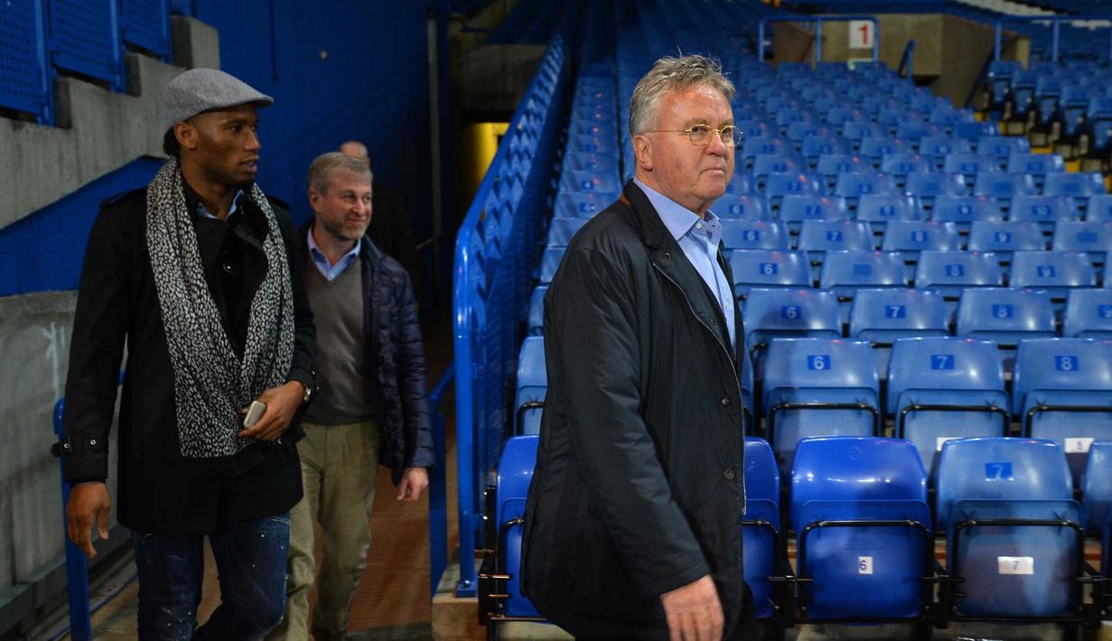 Guus Hiddink (kanan), turun ke lapangan bersama Didier Drogba dan pemilik Chelsea, Roman Abramovich usai Chelsea menang atas Sunderland di Stadion Stamford Bridge, London, Sabtu (19/12/2015). (AFP Photo/Glyn Kirk)