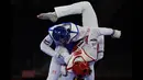 Saleh Elsharabaty dari Yordania (Biru) dan Achraf Mahboubi dari Maroko (Merah) berlomba dalam perempat final taekwondo putra -80kg Olimpiade Tokyo 2020 di Makuhari Messe Hall di Tokyo, Senin (26/7/2021). (Foto: AFP/Javier Soriano)