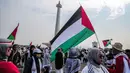 Warga mengikuti aksi damai Bela Palestina di kawasan Monas, Jakarta, Minggu (5/11/2023). (Liputan6.com/Faizal Fanani)