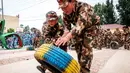 Sejumlah anak-anak mendorong ban saat mensimulasikan latihan militer di sebuah taman kanak-kanak di provinsi Henan, China (30/5). Latihan militer ini dilakukan untuk menjelang Hari Anak Internasional yang jatuh pada 1 Juni. (AFP)