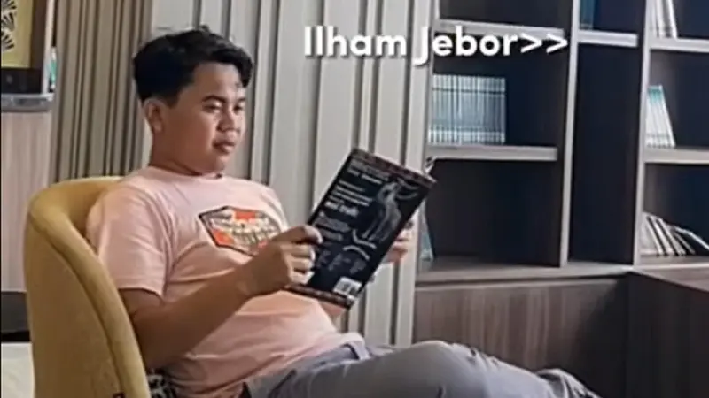 Mas Jebor, pengatut jadwal pengajian Gus Iqdam sedang membaca majalah (Tangkap Layar YouTube Ronji TV)