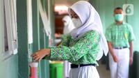 Murid mencuci tangan saat belajar tatap muka dengan penerapan protokol kesehatan COVID-19 di SMAN 2 Cibinong, Kabupaten Bogor, Jawa Barat, Rabu (17/3/2021). Sebanyak 170 sekolah di Kabupaten Bogor mulai menggelar uji coba pembelajaran secara tatap muka hingga 10 April 2021. (merdeka.com/Arie Basuki)