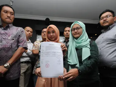 Juru Bicara TemanAhok, Amalia Ayuningtyas (kedua kanan) memegang tanda terima pengajuan judicial review di gedung Mahkamah Konstitusi, Jakarta, Jumat (17/6). Judicial Review terkait UU Pilkada yang direvisi DPR. (liputan6.com/Helmi Fithriansyah)