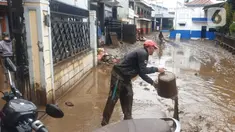 Warga membersihkan lumpur sisa dari banjir bandang Garut di kawasan Cimacan, Desa Jayaraga, Kecamatan Tarogong Kidul, Sabtu (16/7/2022). Pemda Garut, Jawa Barat menyatakan status darurat banjir setelah 8 kecamatan di wilayah tersebut terendam banjir usai Sungai Cimanuk dan beberapa anak sungainya meluap. (Liputan6.com/Jayadi Supriadin)