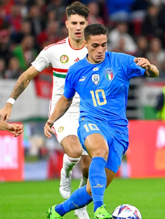 Pemain Italia Giacomo Raspadori (depan) mengontrol bola di depan pemain Hungaria Dominik Szoboszlai pada pertandingan sepak bola UEFA Nations League di Puskas Arena, Budapest, Hungaria, 26 September 2022. Italia berhasil mengalahkan Hungaria dengan skor 2-0. (Tamas Kovacs/MTI via AP)