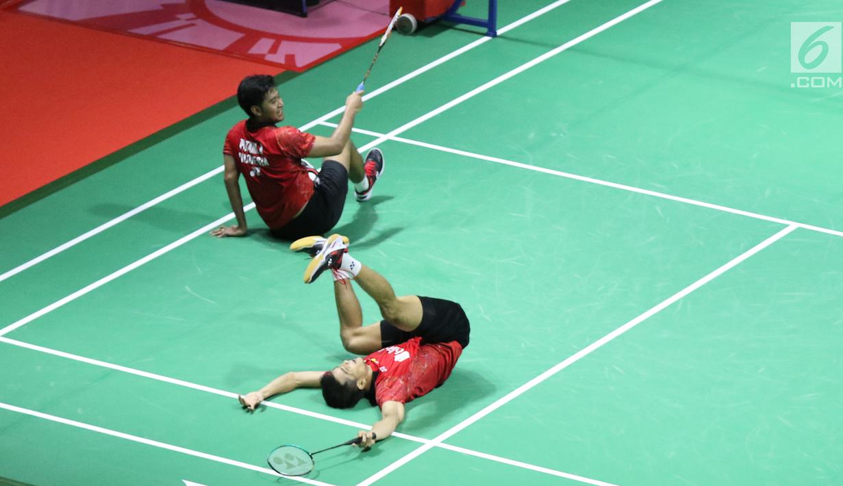 Ganda putra Indonesia, Ricky Karandasuwardi/Angga Pratama terjatuh saat melawan He Jiting/Tan Qiang (China) pada 32 besar Indonesia Open 2018 di Istora GBK, Jakarta, Rabu (4/7). Ricky/Angga unggul 16-21, 21-17, 26-24. (Liputan6.com/Helmi Fithriansyah)