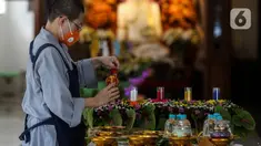 Petugas menyusun gelas lilin pelita menyambut perayaan Waisak di Wihara Ekayana Arama, Jakarta Barat, Selasa (25/5/2021). Wihara ini melakukan persiapan untuk menyambut rangkaian Hari Raya Waisak 2565 BE pada 26 Mei 2021 yang akan berlangsung secara virtual esok hari. (Liputan6.com/Johan Tallo)