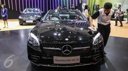 Pekerja mengelap mobil Mercedez Benz AMG SLC 43 saat peluncuran tujuh mobil terbaru Mercedes Benz di Gaikindo Indonesia International Auto Show (GIIAS), ICE BSD, Tangsel, Kamis (11/8). (Liputan6.com/Fery Pradolo)