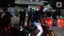 Pemudik motor melintas di posko penyekatan mudik di Kedungwaringin, Kabupaten Bekasi, Jawa Barat, Selasa (11/5/2021) dini hari. Polisi kembali memberlakukan diskresi terhadap pemudik motor yang melintasi jalur Pantura antara Kabupaten Bekasi dan Kabupaten Karawang. (Liputan6.com/Herman Zakharia)