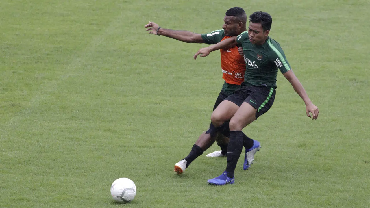Pemain Timnas Indonesia U-22, Marinus Wanewar, berebut bola dengan Nur Hidayat. (Bola.com/Yoppy Renato)