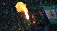 Aksi Debus ala Bonek dengan menyeburkan api saat Persebaya Surabaya melawan Arema FC pada lanjutan Liga 1 Indonesia 2018 di Stadion Gelora Bung Tomo, Surabaya (6/5/2018). Persebaya Surabaya menang tipis 1-0. (Bola.com/Aditya Wany)
